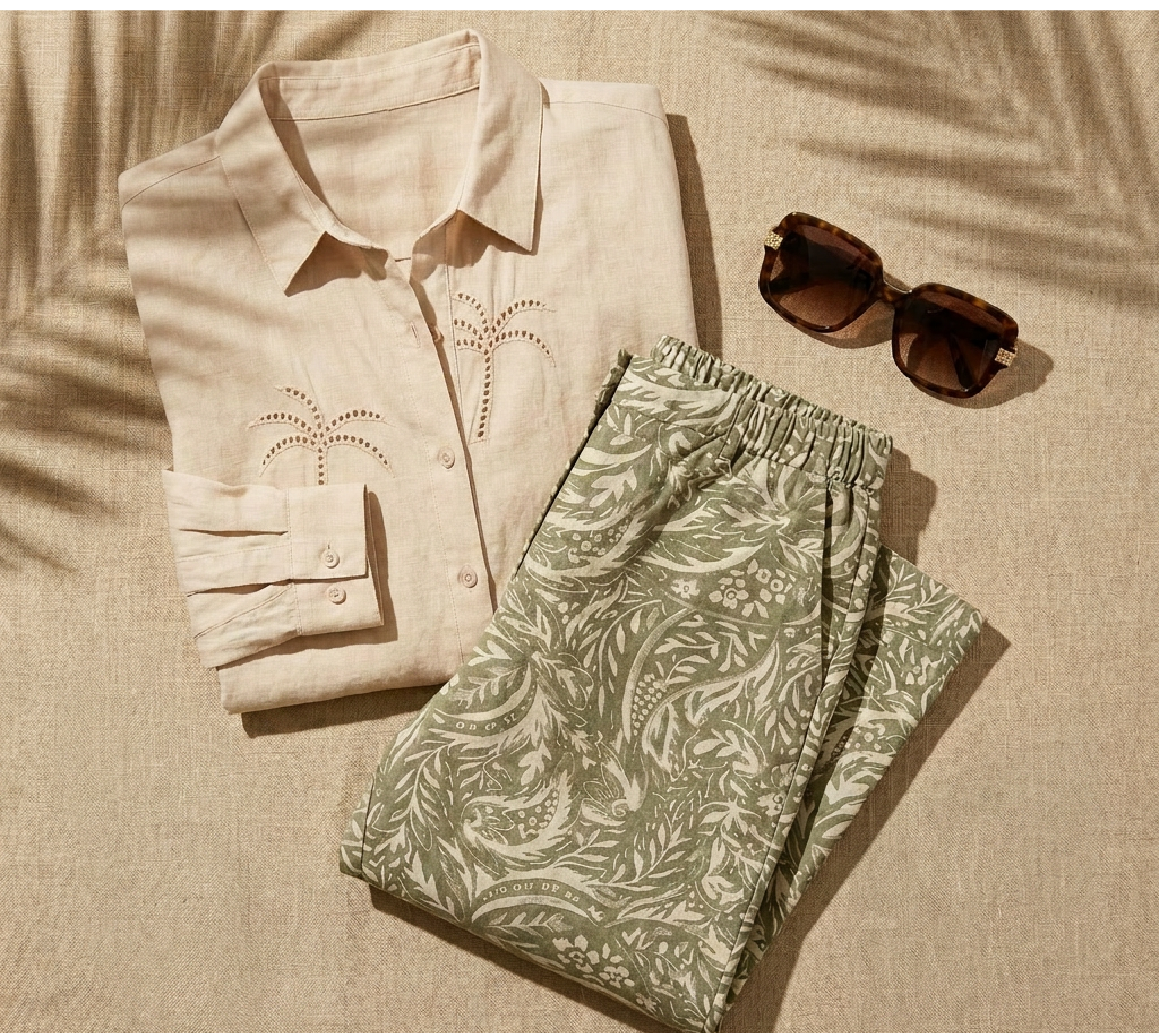 Explore our Styled For You collection! Featuring a khaki embroidered palm tree shirt, green paisley print pant, and a pair of brown sunglasses.