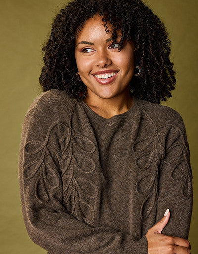Explore our sweaters! Featuring a brown leaf braid detail sweater.