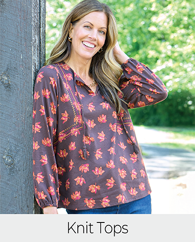 Explore our knit tops! Featuring a brown embroidered tie neck top.