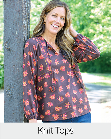 Explore our knit tops! Featuring a brown embroidered tie neck top.