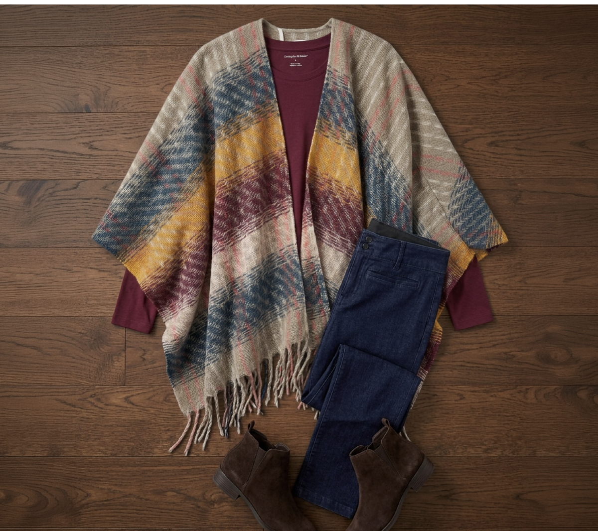 Explore our Styled For You collection! Featuring a multi plaid poncho topper, burgundy long sleeve tee, and blue jeans.