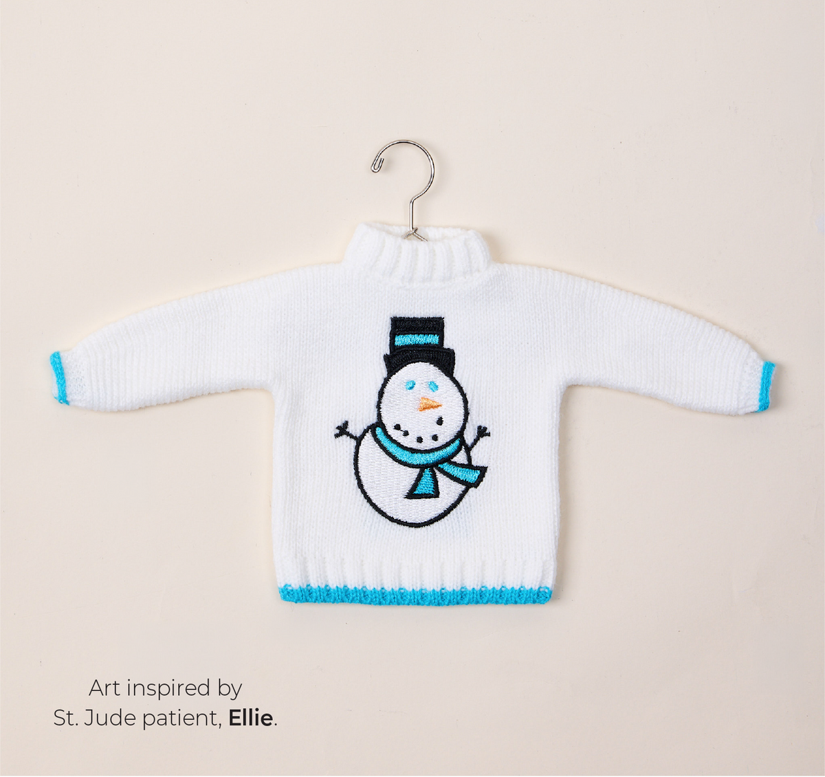 Featuring a white St. Jude Sweater Ornament. Art inspired by St. Jude patient, Ellie.