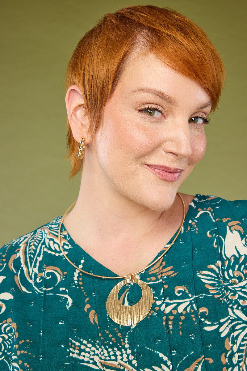 Explore our jewelry! Featuring a gold short circle pendant necklace.