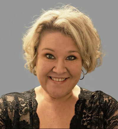 Person with blonde hair against a plain background