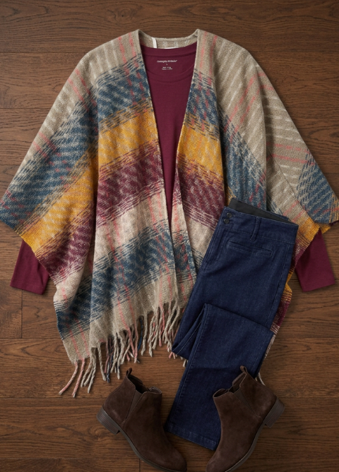 Explore our Styled For You collection! Featuring a multi plaid poncho topper, burgundy long sleeve tee, and blue jeans.