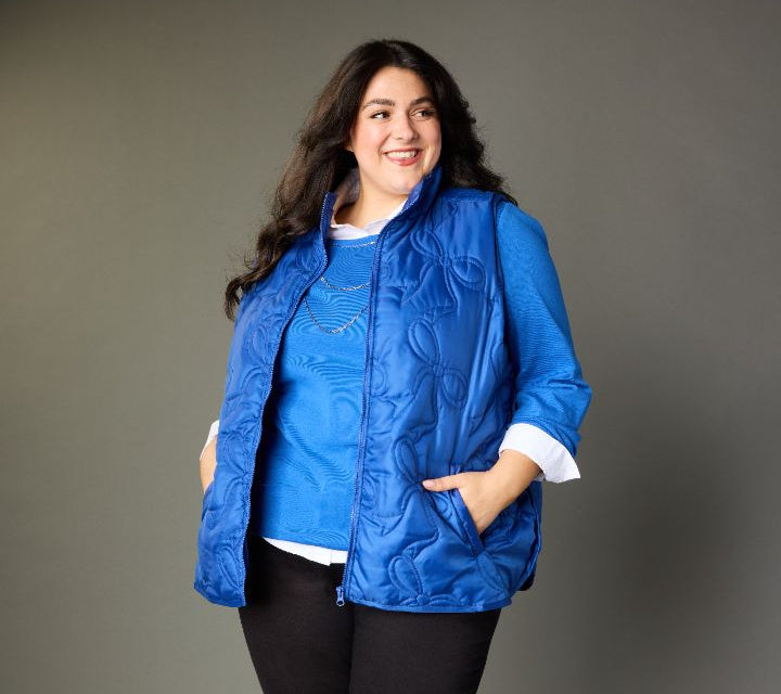 Explore our vests! Featuring a blue quilted vest.