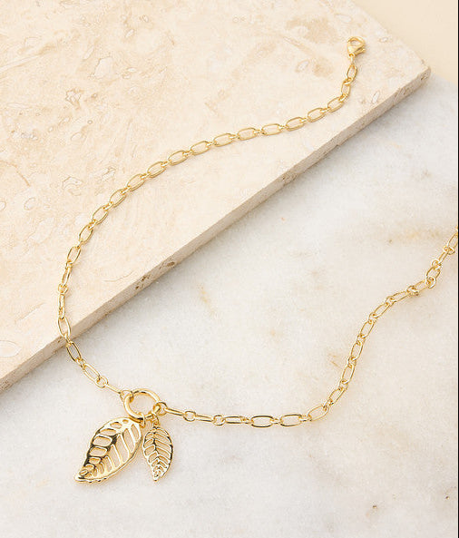 Explore our jewelry! Featuring a gold leaf pendant necklace.