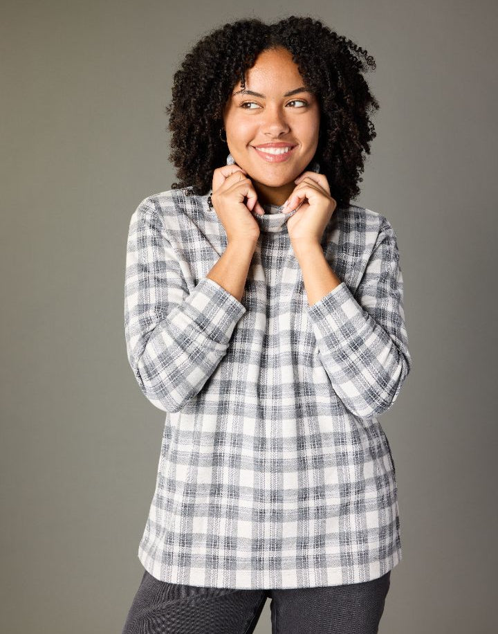 Explore our knit tops! Featuring a plaid turtleneck.